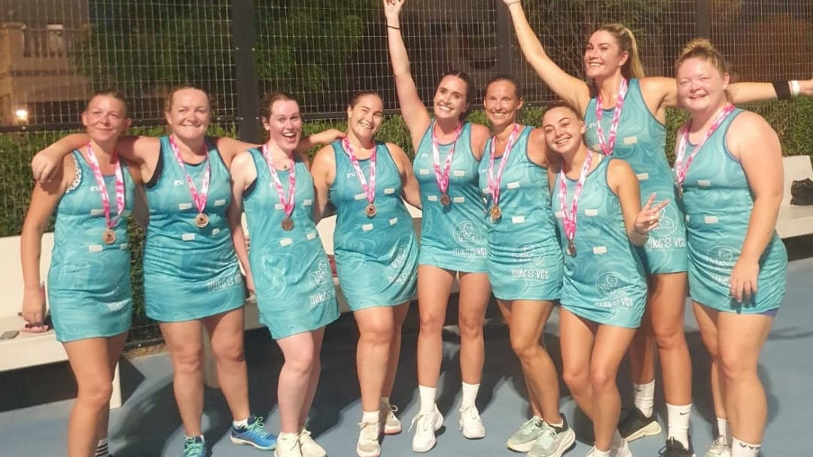 A netball team with their medals